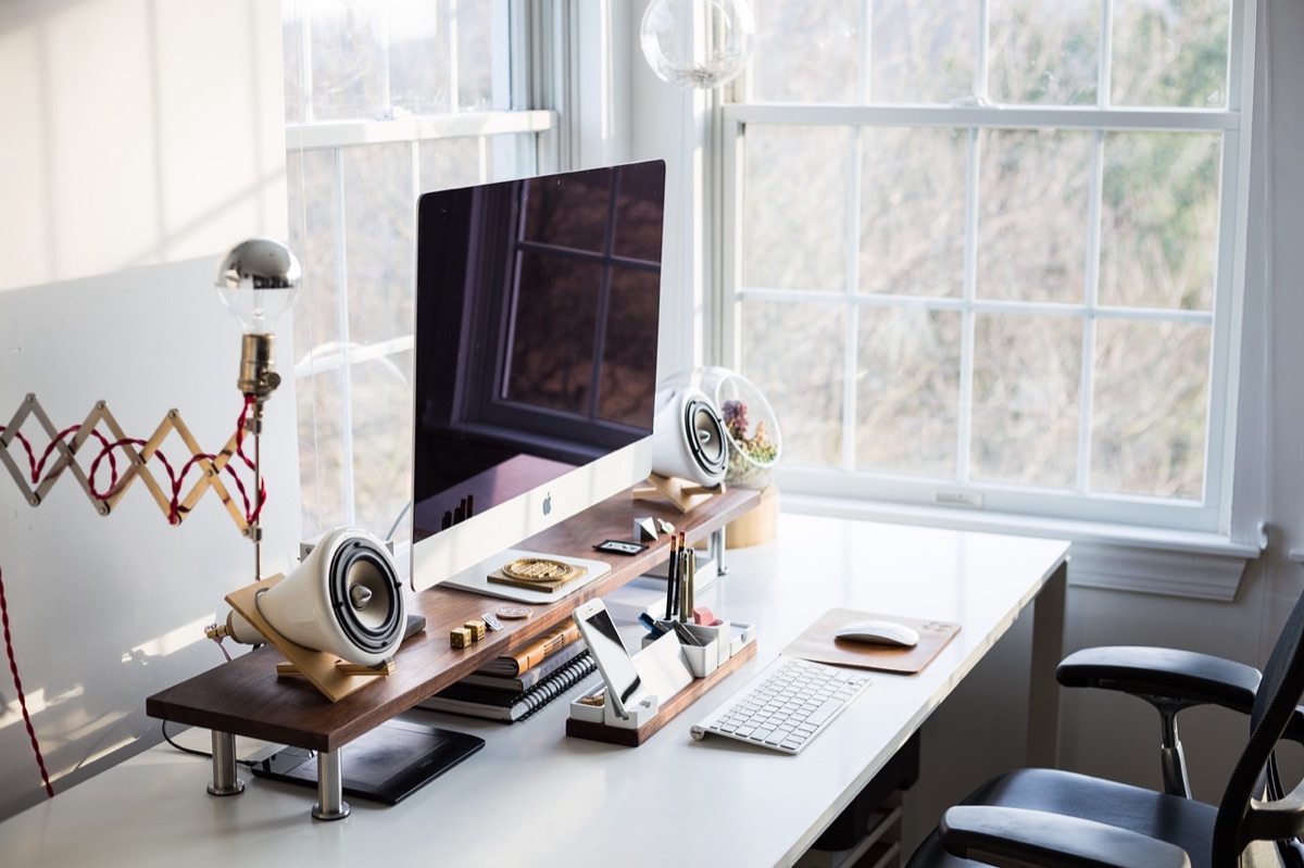 A clean dual monitor computer setup with organized desk accessories